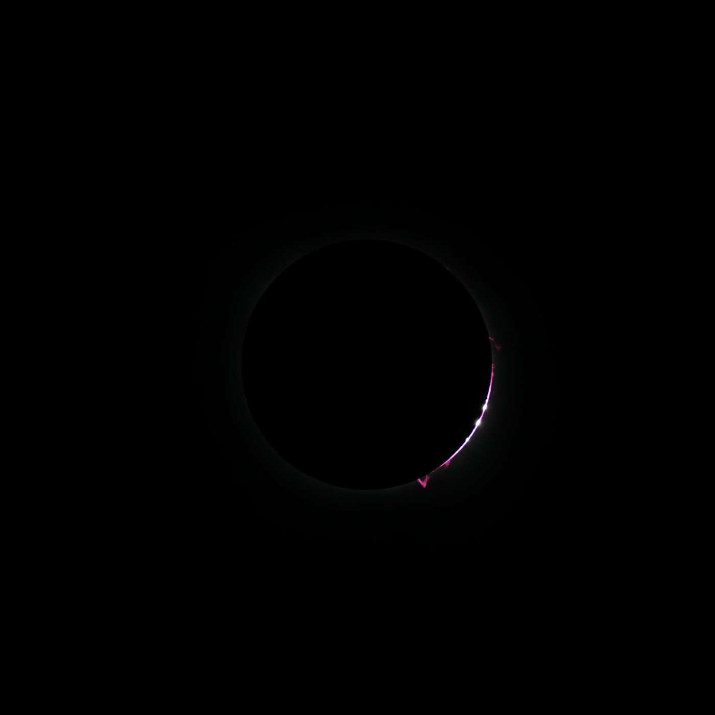 Baily's beads glowing along the moon's edge during the 2024 total solar eclipse